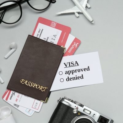 Flat lay composition with passport, toy plane and tickets on light grey background, space for text. Visa receiving